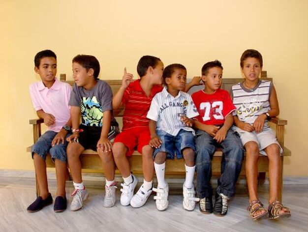Un grupo de chicos posan sentados en un banco.

Foto: Manu Garc?