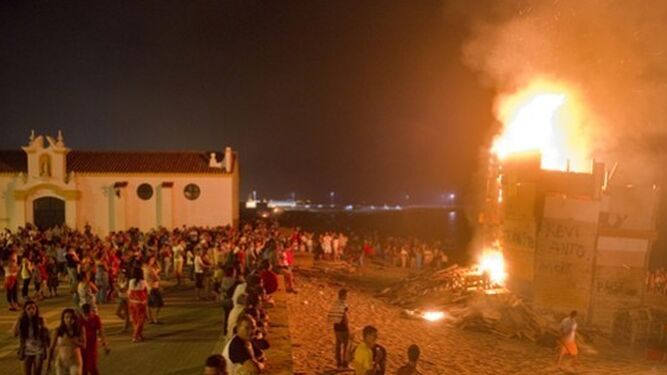 Una hoguera arde un 23 de junio por la noche junto a la iglesia del Carmen.
