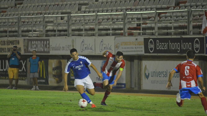 El capitán del Algeciras, Iván Turrillo, pugna con un  jugador del San Fernando durante el duelo de ida disputado en el Nuevo Mirador.