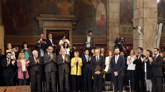 Quim Torra y  Roger Torrent reciben el aplauso de los nuevos 'consellers' del gobierno catalán a su llegada al acto de toma de posesion del nuevo Govern.