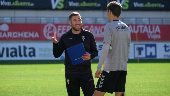 Javi Motos conversa con un futbolista del Real Murcia durante un entrenamiento