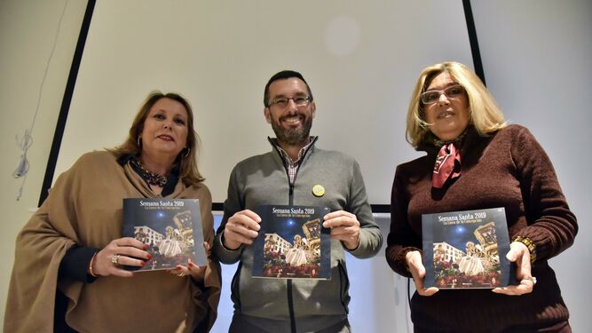 María José Cuevas, Juan Franco y Carmen Toribio muestran la revista oficial de la Semana Santa de La Línea.