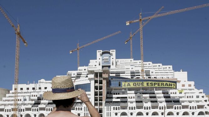 Un hombre hace una foto a la edificación del hotel del Algarrobico.
