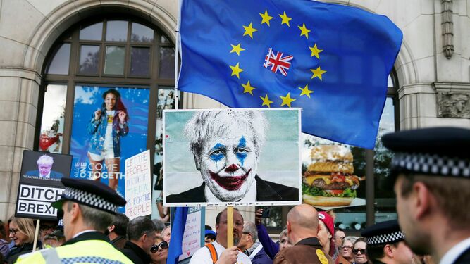 Un manifestante en contra del Brexit porta una foto de Boris Johnson caracterizado como Joker.