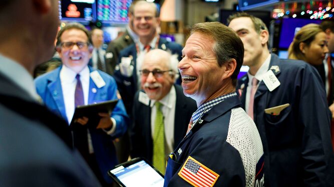 Varios corredores de bolsa sonríen en la apertura de Wall Street.