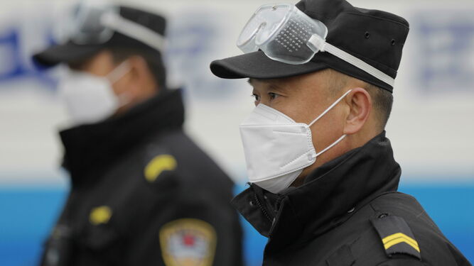 Guardias de seguridad con mascarillas en Pekín.