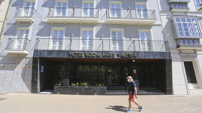 Un hombre pasa con mascarilla ante un hotel de Málaga.