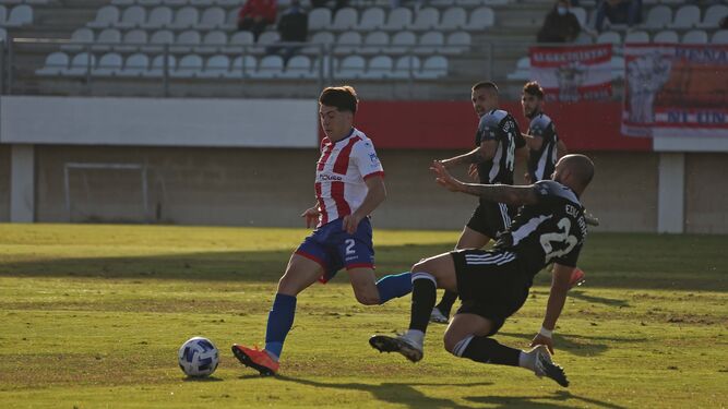 Álvaro Alcázar lleva el balón ante una entrada de Edu Ramos.