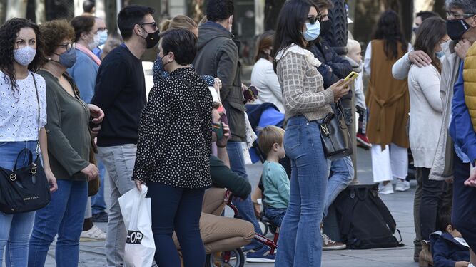 Varias personas con mascarillas en el centro de Sevilla antes del estado de alarma