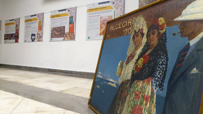 Cartel de la Feria taurina de Algeciras 1915 &Oacute;leo sobre lienzo de Mariano Bertuchi con escena de dos mujeres ataviadas con trajes de fiesta de principios de siglo y un hombre.