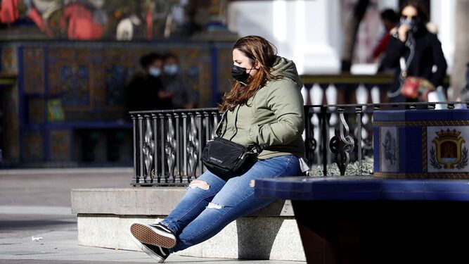 Una mujer descansa en un banco de la Plaza Alta de Algeciras.