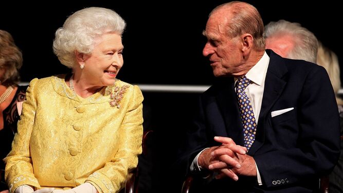 Isabel II y Felipe de Edimburgo charlan en un acto oficial.