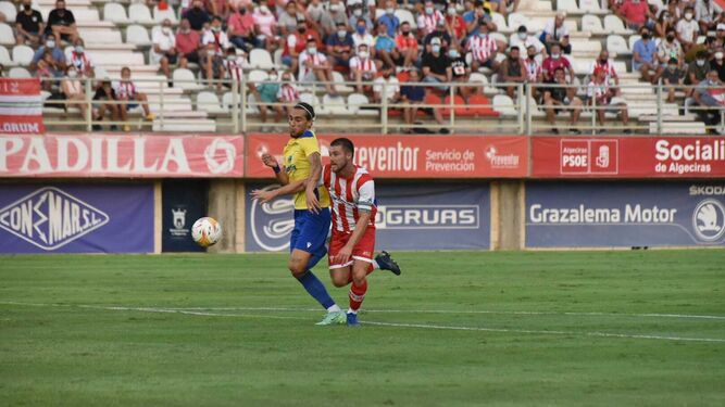 Almenara corre con el balón ante un defensor del Cádiz.