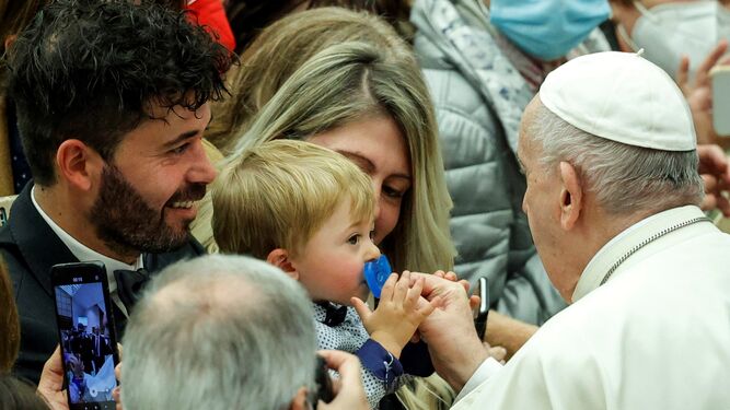 El Papa Francisco da la paz a un bebé durante la audiencia semanal en la Ciudad del Vaticano.