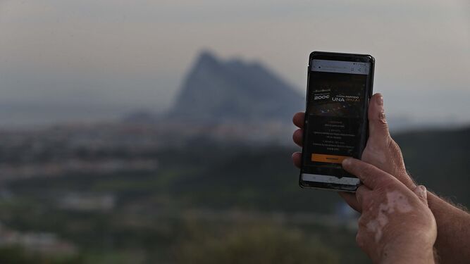 Una persona apuesta  desde su teléfono con Gibraltar  al fondo (foto de archivo).