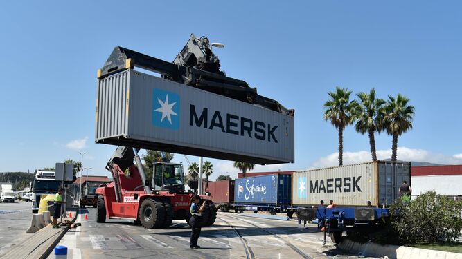 Una grúa carga un contenedor en un convoy ferroviario en el Puerto de Algeciras.