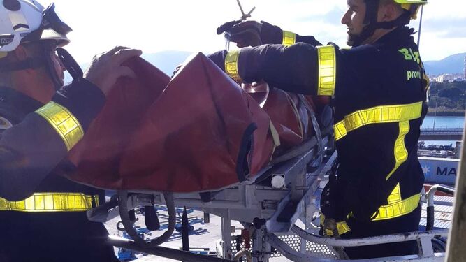 Los bomberos rescatan a un operario de grúa en el Puerto de Algeciras.