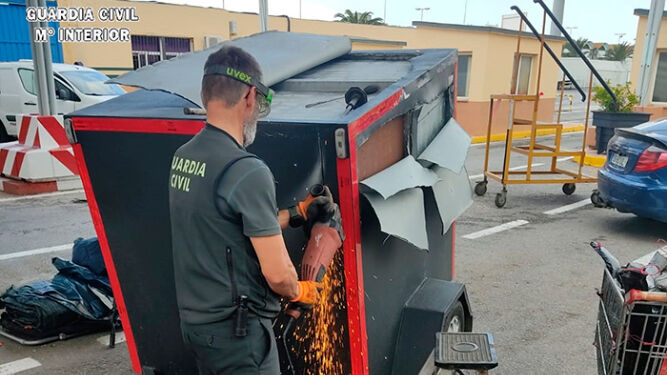 Un agente abre un remolque con hachís oculto en el Puerto de Ceuta.