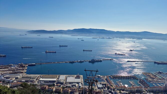 Base naval de Gibraltar. Dos patrulleros y un buque de guerra anfibia en puerto. La bahía de Algeciras con un buen número de barcos fondeados. Al fondo, el puerto de Algeciras.